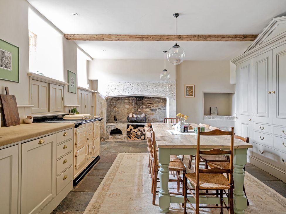 A kitchen with table and chairs at Batheaston House in Batheaston
