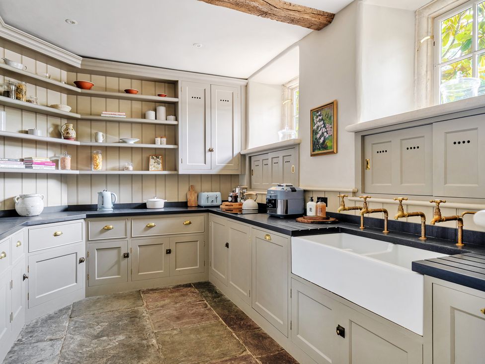A kitchen with cabinets and a sink at Batheaston House in Batheaston