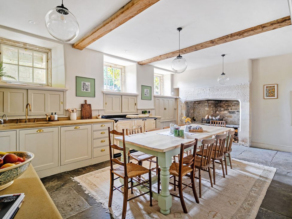 A kitchen with a dining table and chairs at Batheaston House in Batheaston