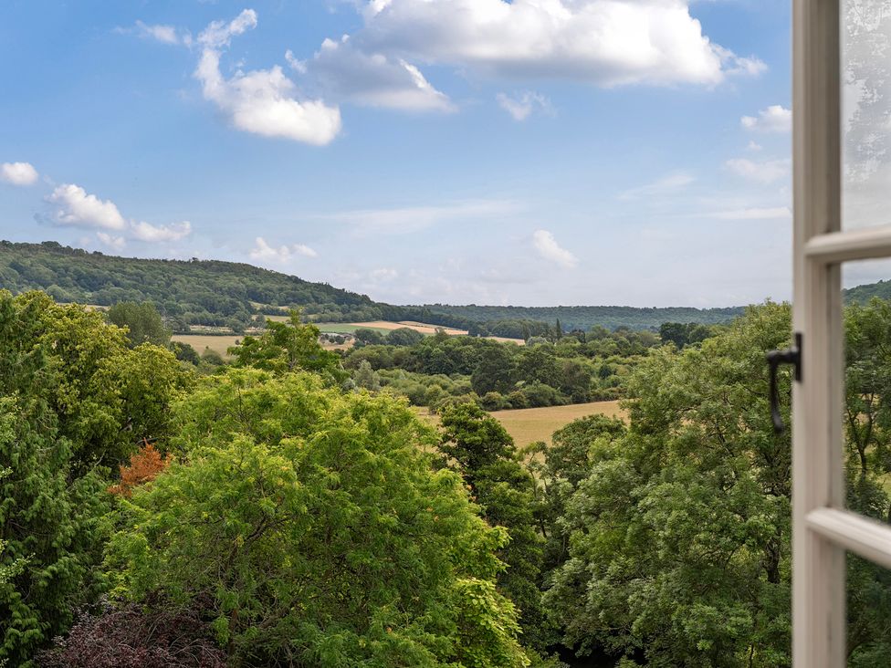 A view of trees and fields from a window at Batheaston House in Batheaston