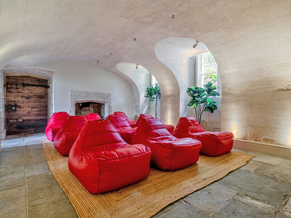 A snug with bean bags and a wooden door at Batheaston House in Batheaston