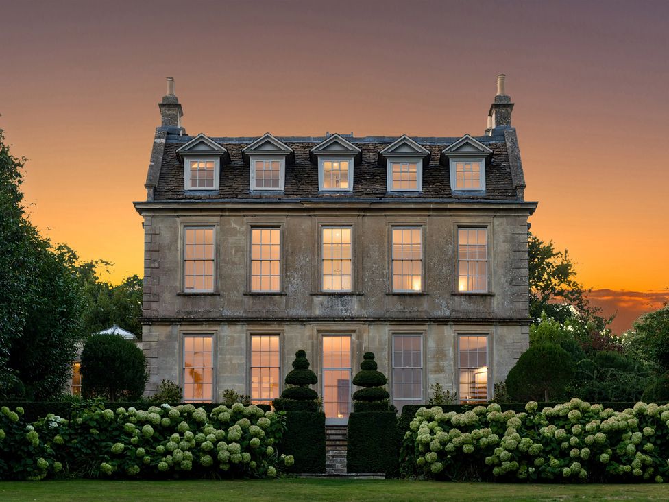 A house with multiple windows and a garden at Batheaston House in Batheaston