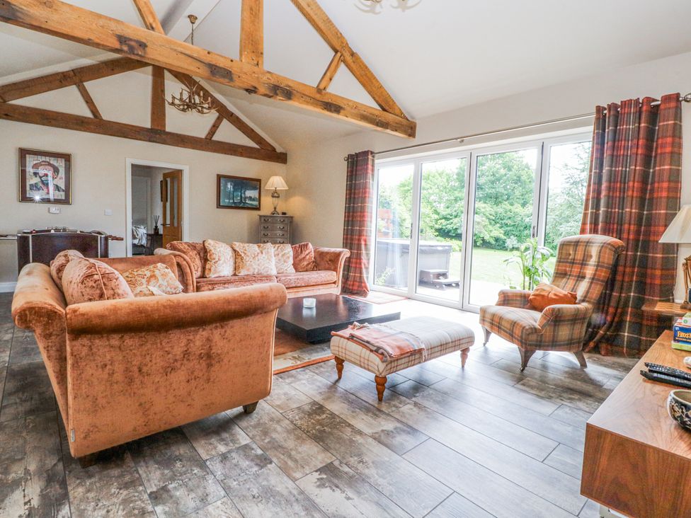 A living room with a sofa and coffee table at The Old Coach House in Bilsborrow