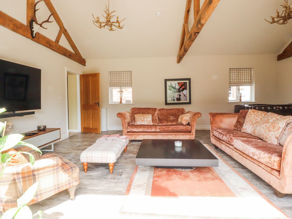 A living room with a sofa and coffee table at The Old Coach House in Bilsborrow