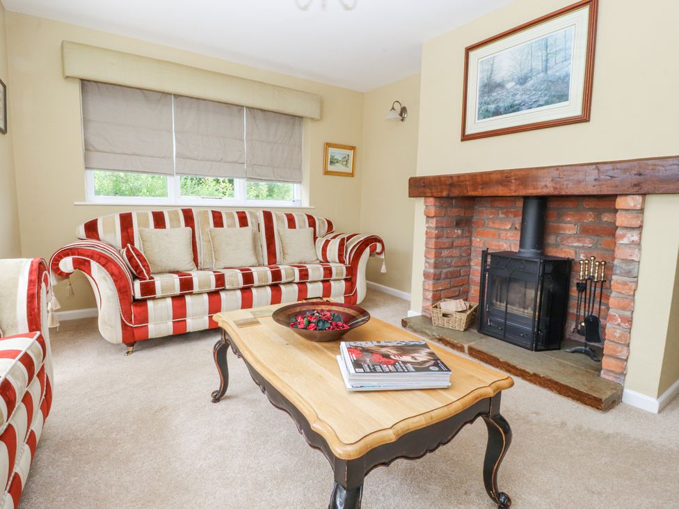 A living room with couches and a fireplace at The Old Coach House in Bilsborrow