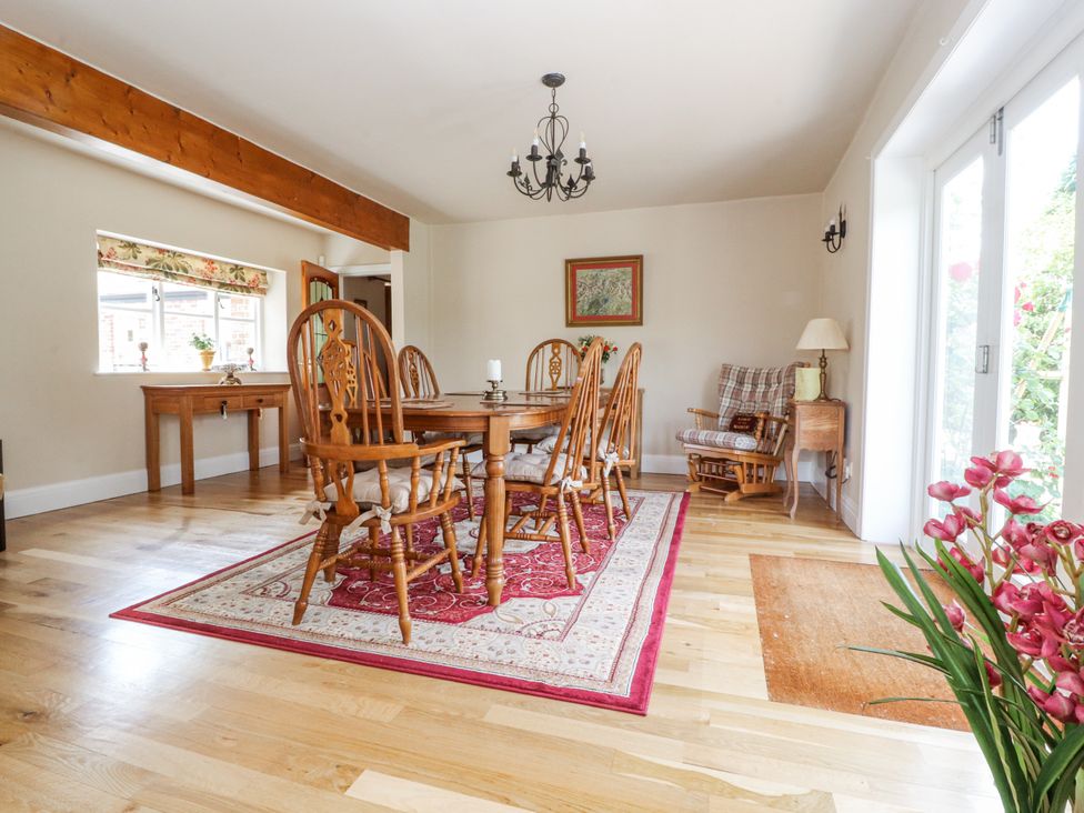 A dining room with a wooden table and chairs at The Old Coach House Bilsborrow