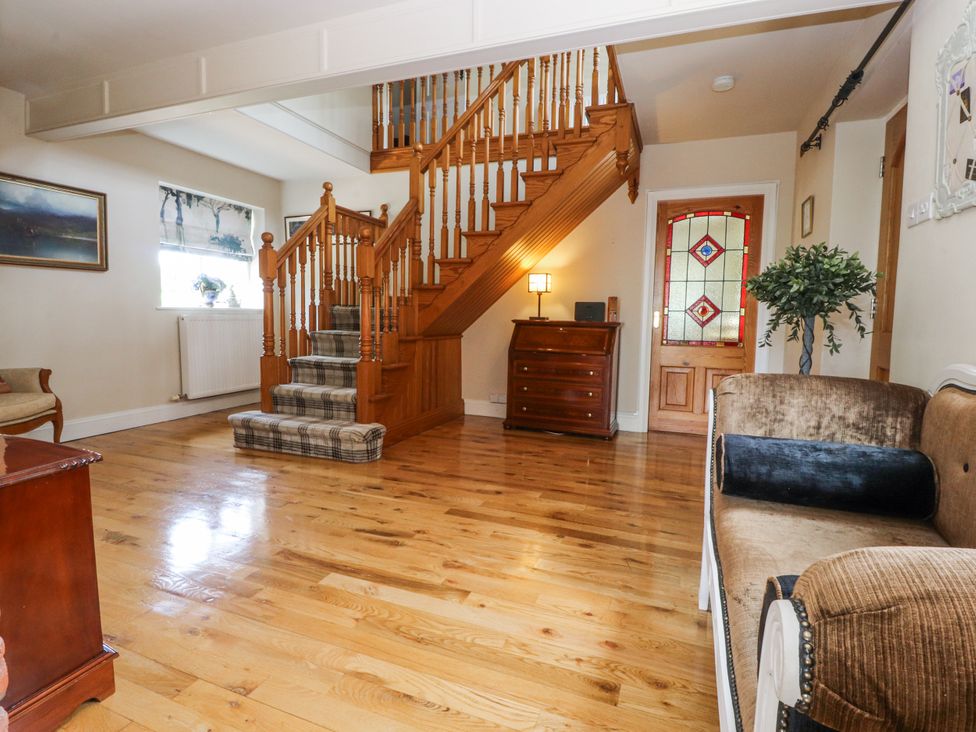 An entryway with a staircase and furniture at The Old Coach House in Bilsborrow