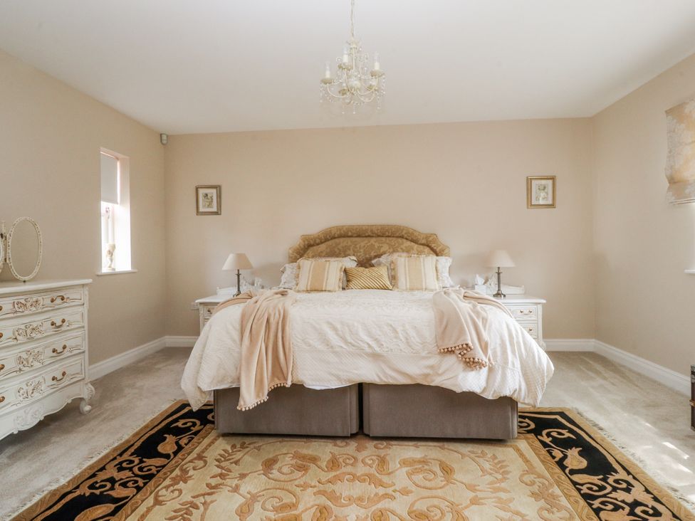 A bedroom with a bed and nightstands at The Old Coach House in Bilsborrow