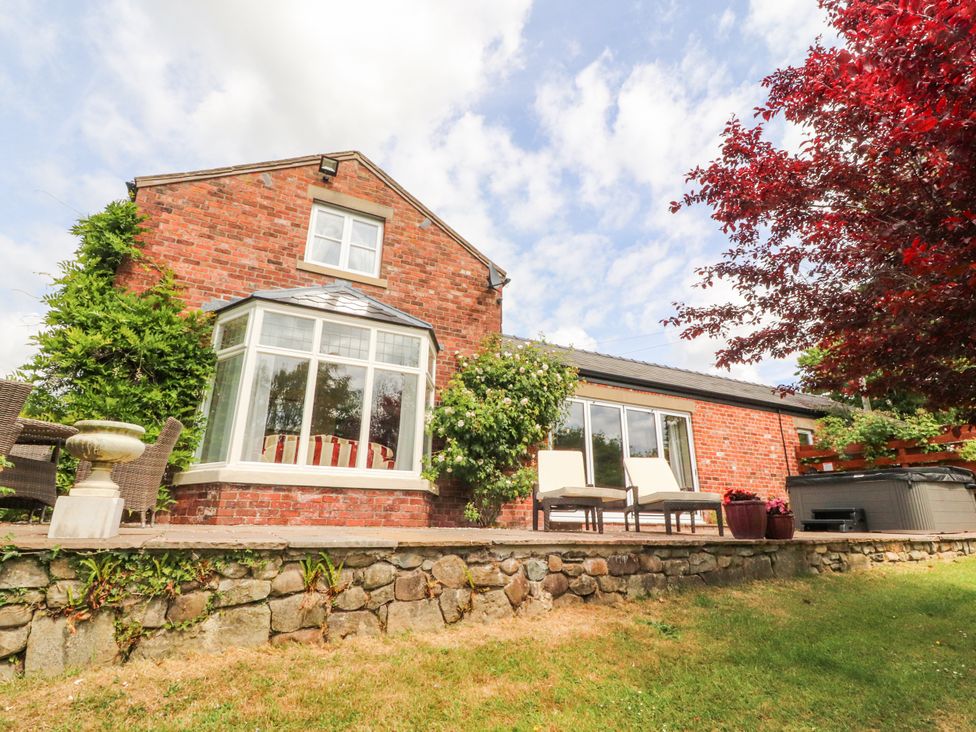 A house with a garden and patio at The Old Coach House in Bilsborrow
