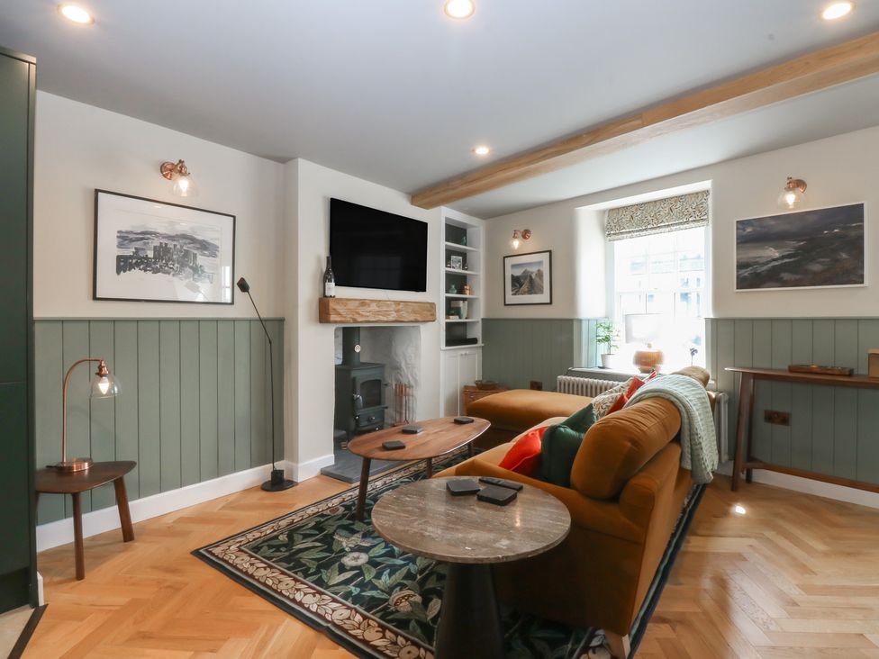 A living room with a sofa and coffee table at Hilltop Cottage in Conwy