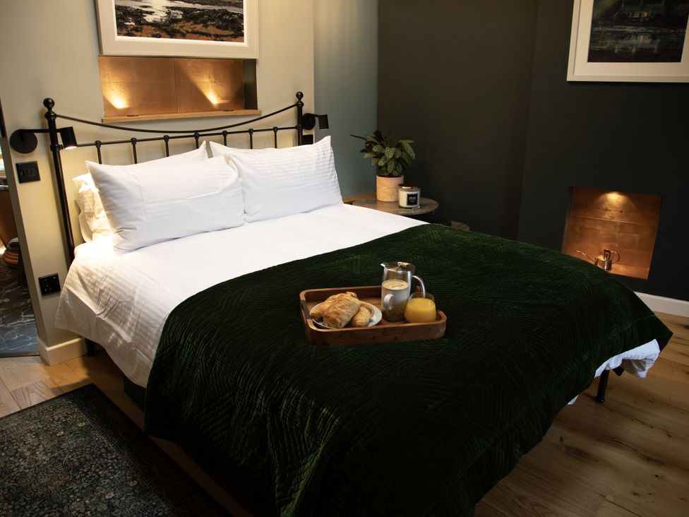 A bedroom with a bed and breakfast tray at Hilltop Cottage in Conwy