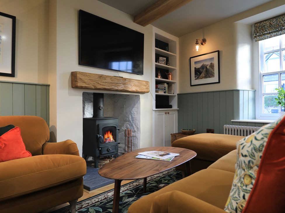 A living room with a sofa and coffee table at Hilltop Cottage in Conwy