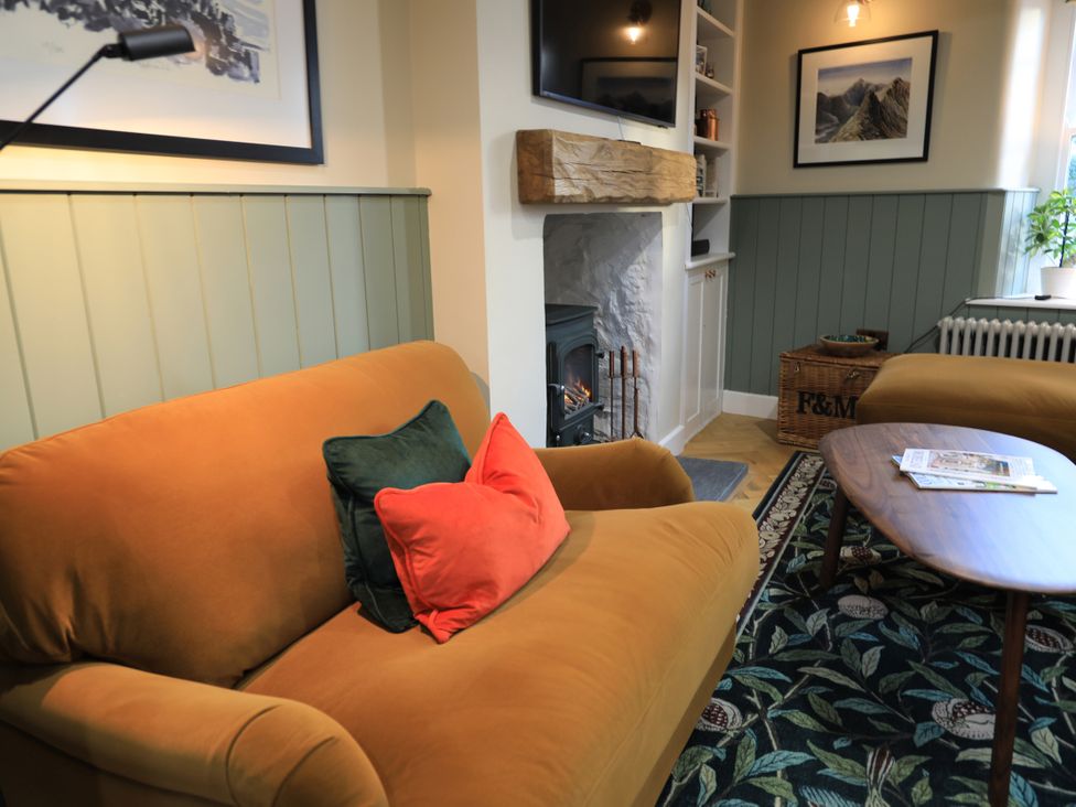 A living room with a sofa and coffee table at Hilltop Cottage in Conwy