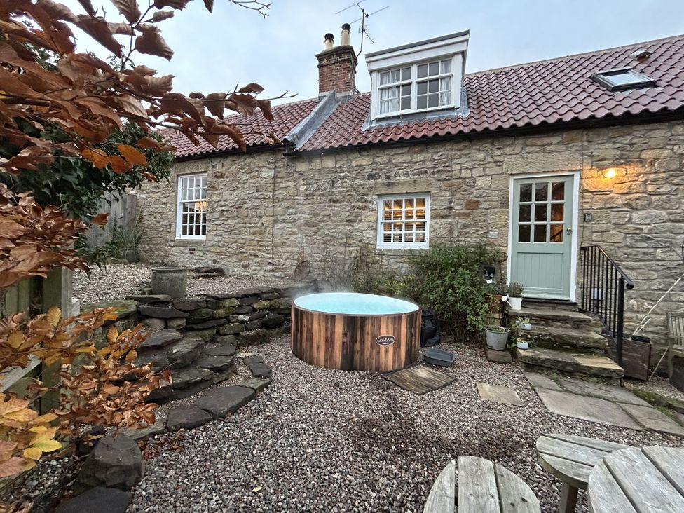 An outdoor area with a hot tub and stone steps at The Poachers Pocket Whittingham near Alnwick
