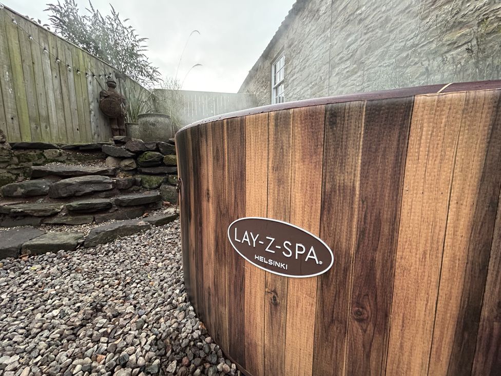 A hot tub in a garden area at The Poachers Pocket in Whittingham near Alnwick
