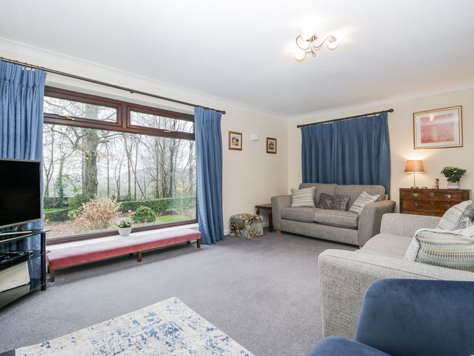 A living room with a sofa and television at Beech Brae in Kendal