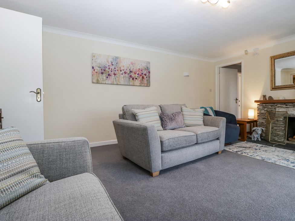 A living room with sofas and a fireplace at Beech Brae Kendal