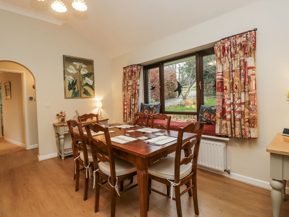 A dining room with a table and chairs at Beech Brae in Kendal