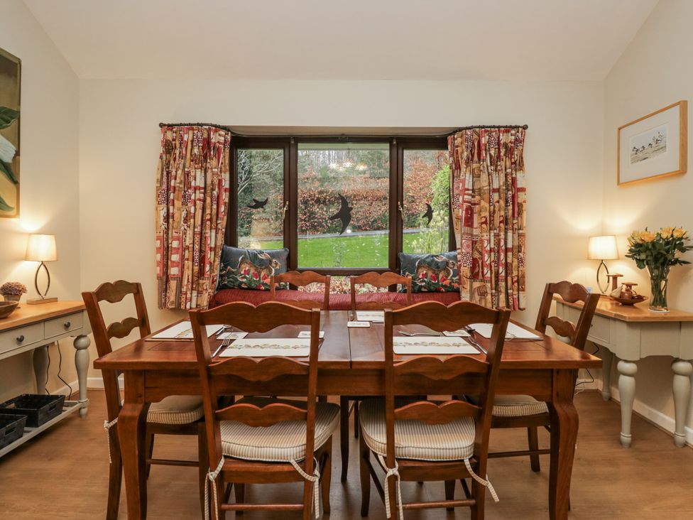 A dining room with a table and chairs at Beech Brae in Kendal
