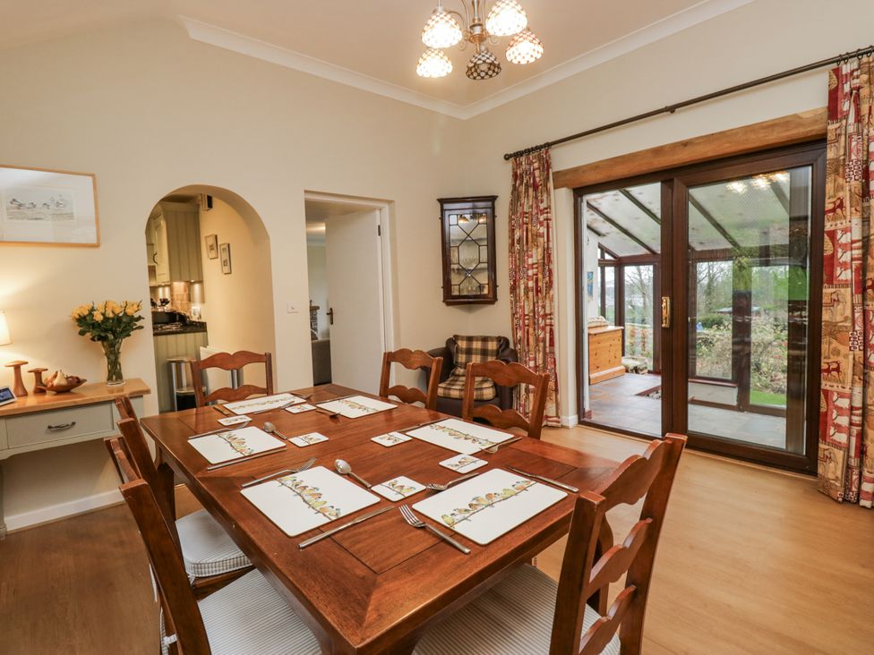 A dining room with a table and chairs at Beech Brae in Kendal