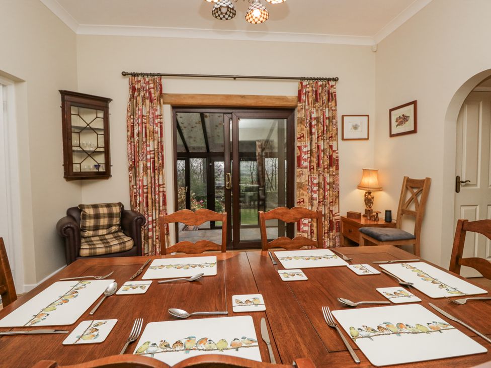A dining room with a table set for meals at Beech Brae in Kendal