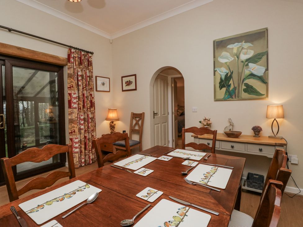 A dining room with a table and chairs at Beech Brae Kendal