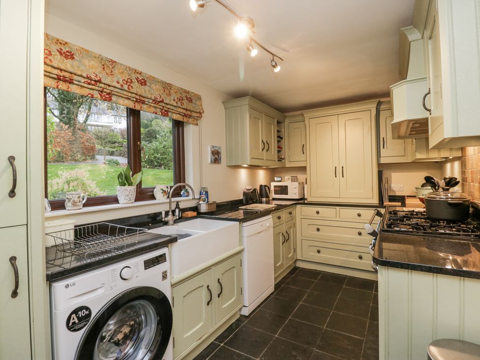 A kitchen with appliances and cabinets at Beech Brae in Kendal