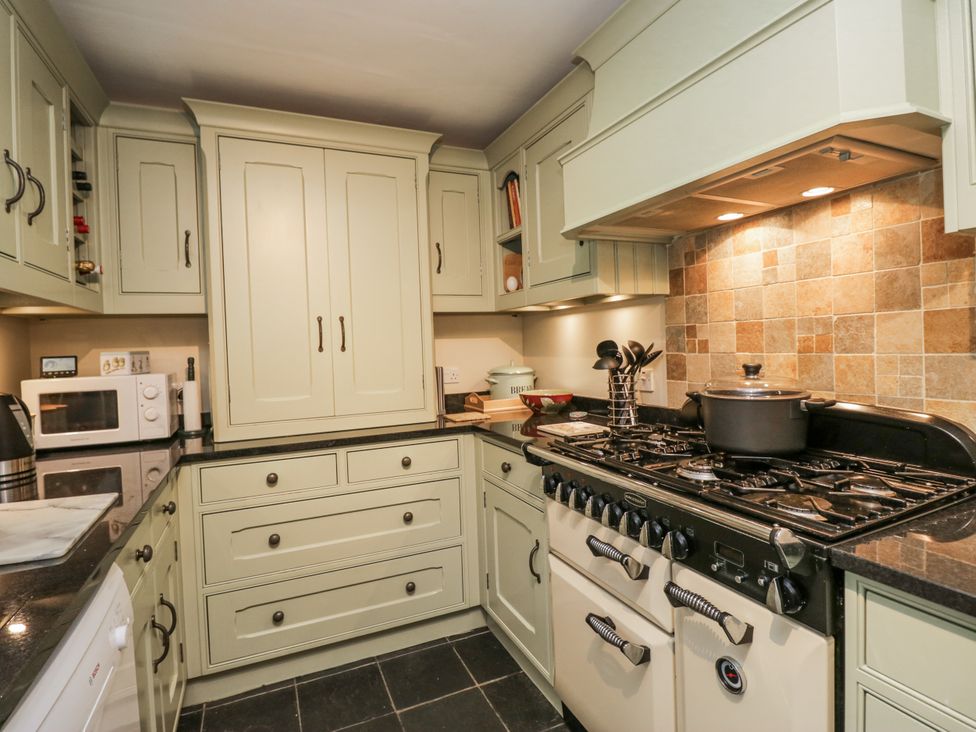 A kitchen with cabinets and stove at Beech Brae in Kendal