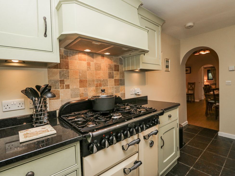 A kitchen with a stove and cooking pot at Beech Brae Kendal