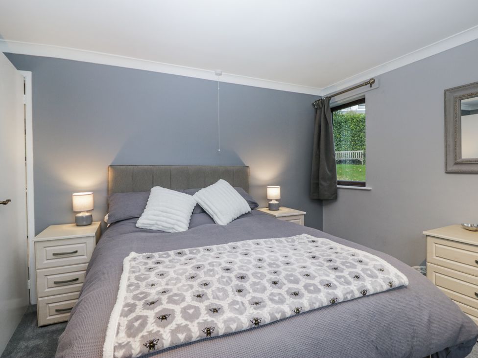 A bedroom with a bed and bedside tables at Beech Brae in Kendal