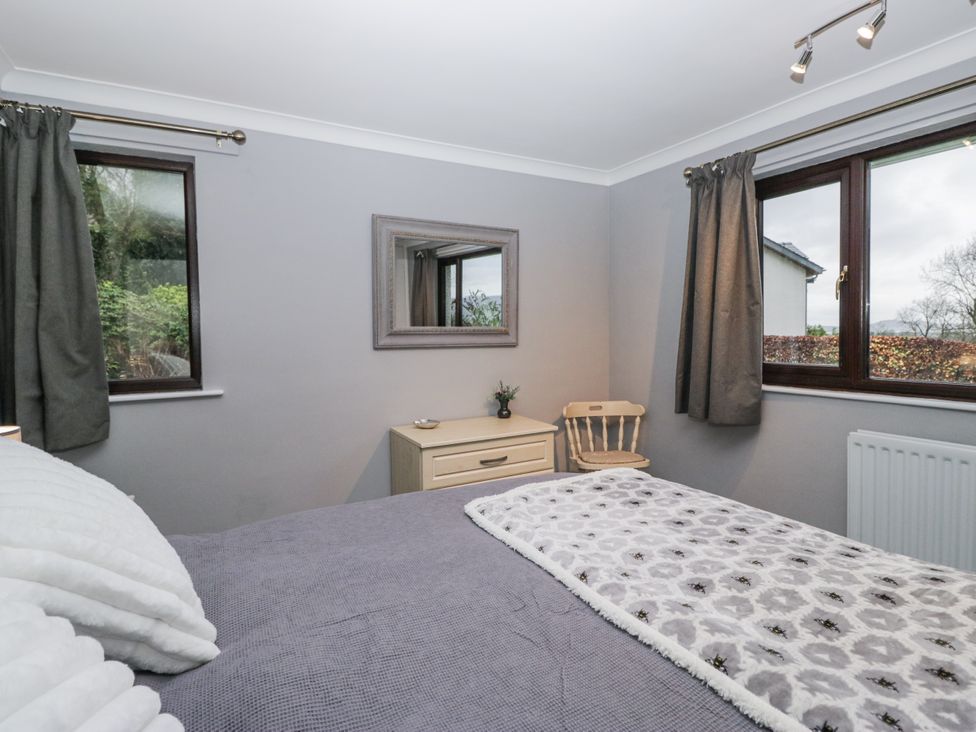 A bedroom with a bed and a dresser at Beech Brae in Kendal