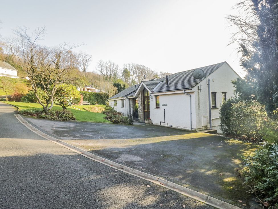 A house with a driveway and garden at Beech Brae in Kendal