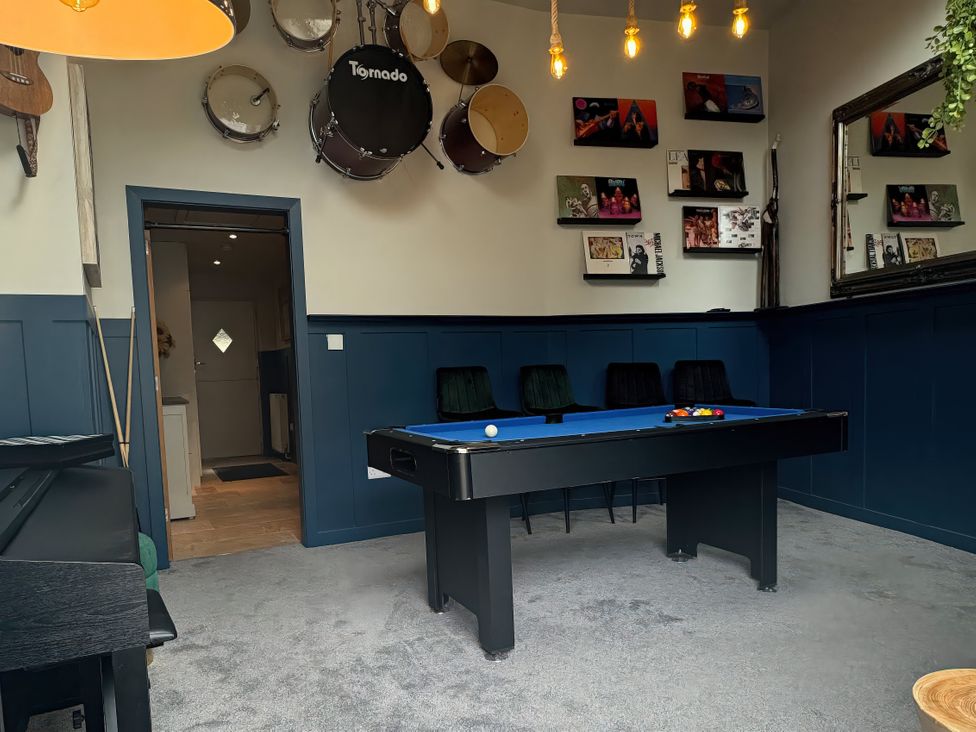 A games room with a pool table and bar stools at Johns Cottage in Harrogate
