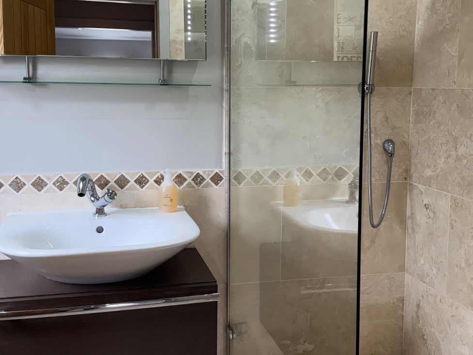A bathroom with a washbasin and shower at Johns Cottage in Harrogate