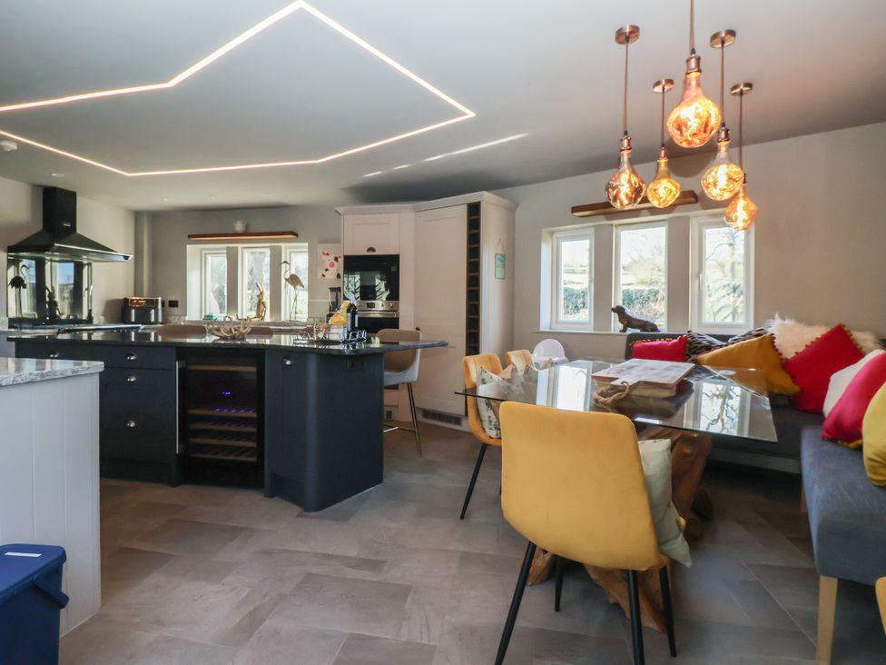 A kitchen with an island and dining table at Johns Cottage in Hampsthwaite