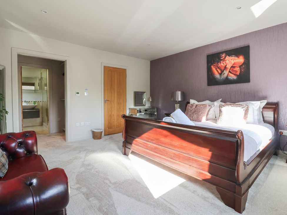 A bedroom with a bed and nightstand at Johns Cottage in Hampsthwaite