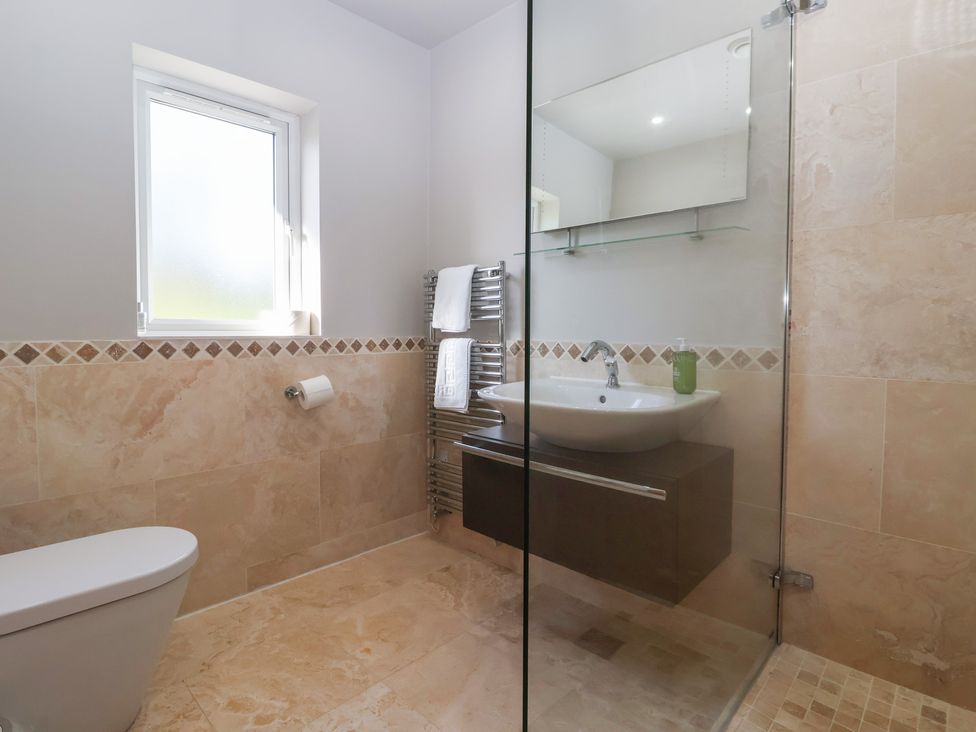 A bathroom with a shower and sink at Johns Cottage in Hampsthwaite
