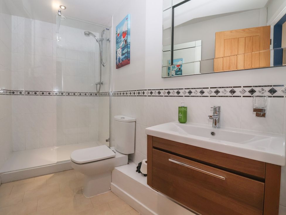 A bathroom with a shower, toilet, and sink at Johns Cottage in Hampsthwaite