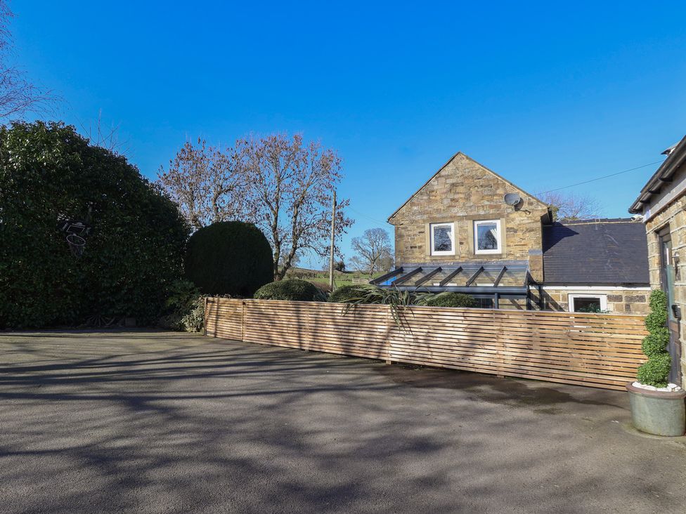 An outdoor area with a house and trees at Johns Cottage in Hampsthwaite