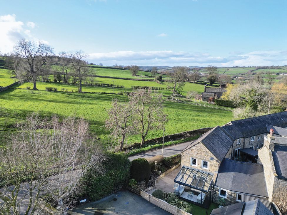 A view of a field and trees from a house at John’s Cottage in Hampsthwaite