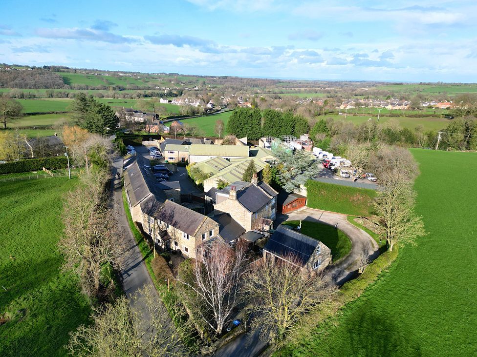 An aerial view of buildings and greenery at Johns Cottage in Hampsthwaite