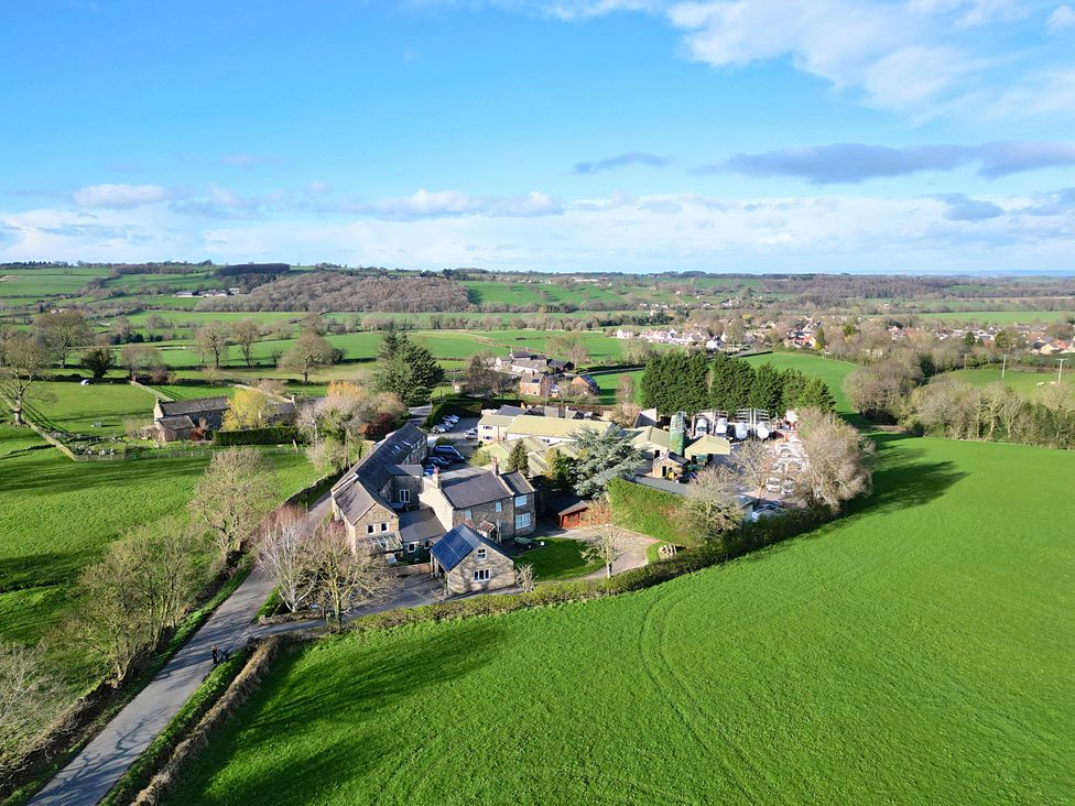 An aerial view of a countryside landscape with fields and buildings at Johns Cottage in Hampsthwaite