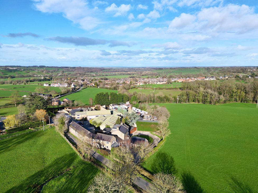 An aerial view of fields and houses at Johns Cottage in Hampsthwaite