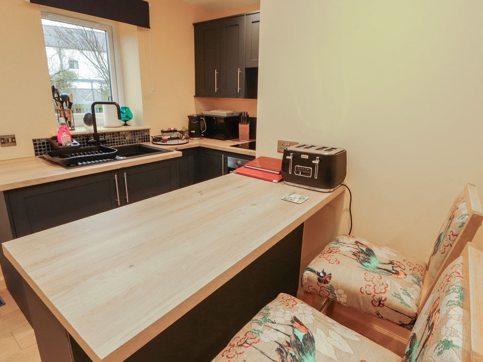 A kitchen with countertop and kitchen utensils at The Nook 