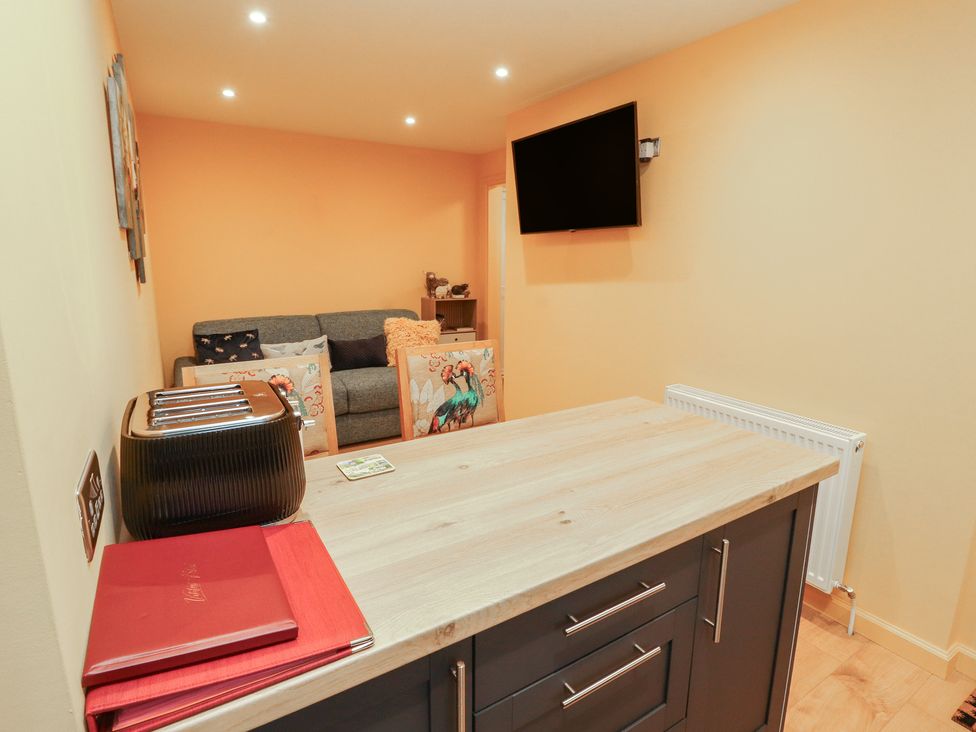 A kitchen with a table and toaster at The Nook in 