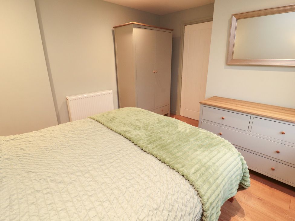 A bedroom with a bed and wardrobe at The Nook in 