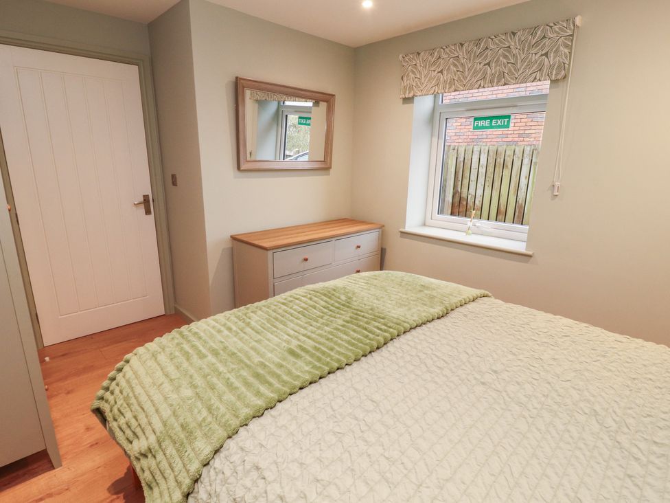 A bedroom with a bed and a window at The Nook in 