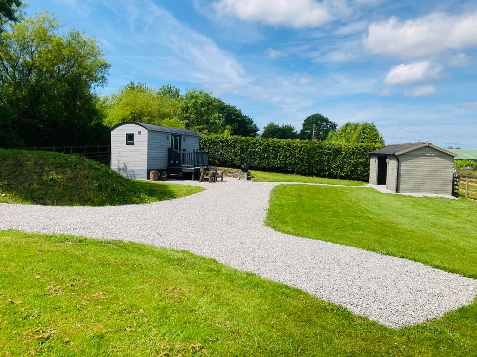 An outdoor area with a trailer and a shed at Little Acre in Oxenhope