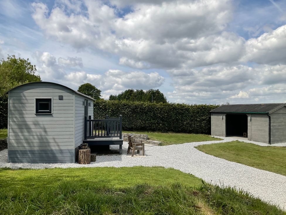 An outdoor area with a shed and deck at Little Acre in Oxenhope
