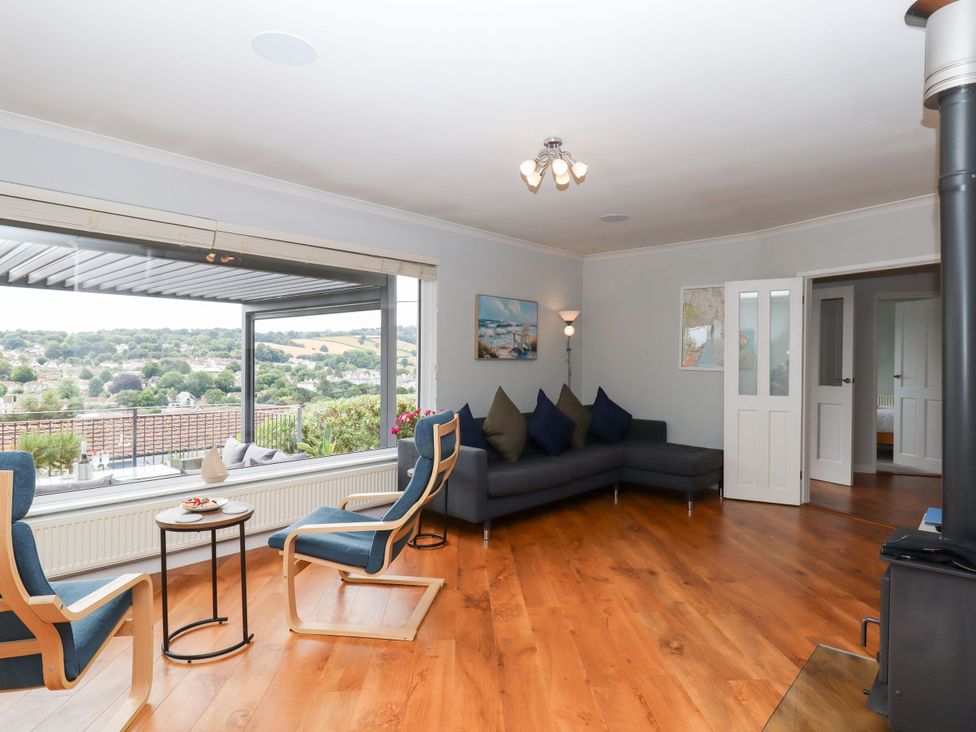 A living room with a sofa and armchairs at 15 Summerland Avenue Dawlish
